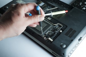 man fixing computer